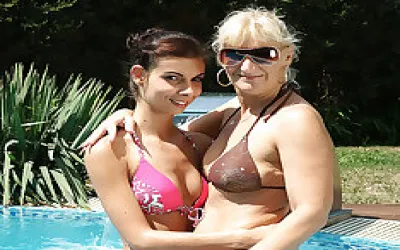 Hot Babe And Her Mature Girlfriend Making Out At The Pool